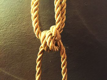 Close-up of ropes tied against wall
