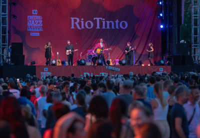 Group of people on street in city at night