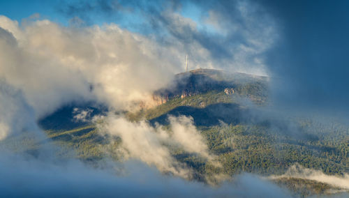Mountain showing through gap in the clouds