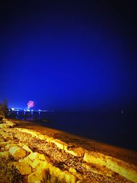 Scenic view of sea against clear blue sky at night