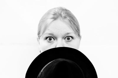 Close-up portrait of young woman against white background