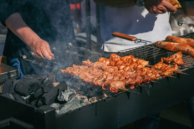 Man preparing food on barbecue grill