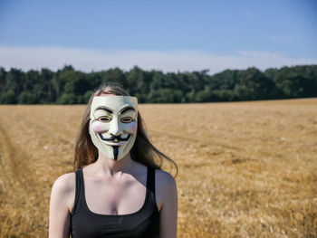 Young woman standing on field