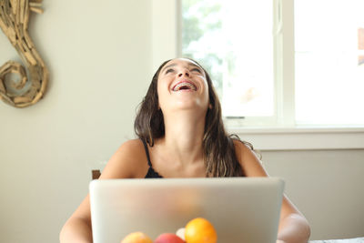 Young woman using mobile phone at home