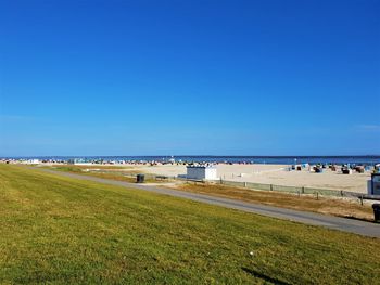 Scenic view of beach against clear blue sky