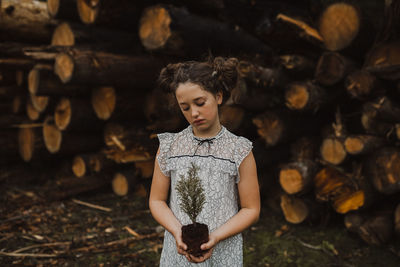 Portrait of young woman standing on field