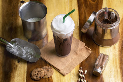 Ice cocoa soft drink on wood floor and topping