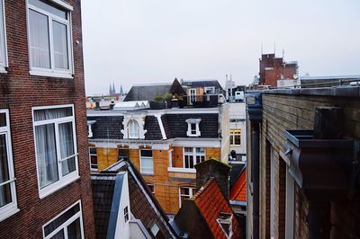 Houses in city against clear sky