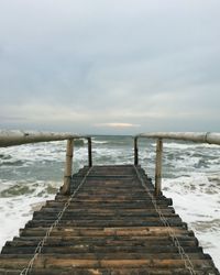 Pier over sea against sky