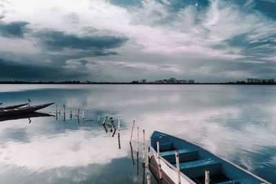 Pier over lake against sky