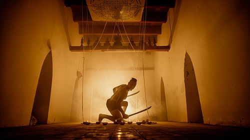 Side view of man against building