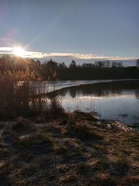 Scenic view of lake against sky during sunset