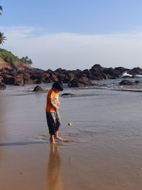 Man standing on beach against sky