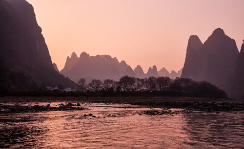 Scenic view of silhouette mountain against sky during sunset