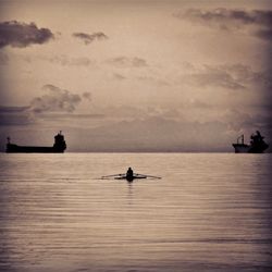 Boat sailing in sea at sunset