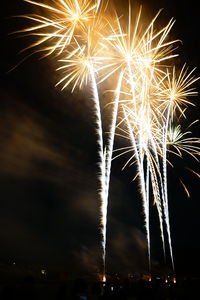 Low angle view of firework display at night