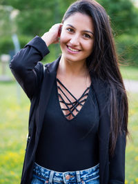 Portrait of young woman standing outdoors