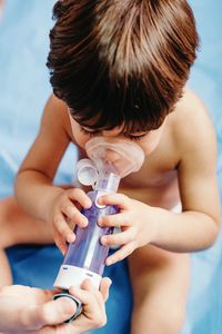 Midsection of shirtless boy playing