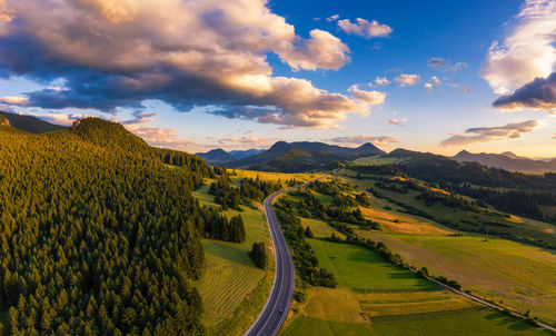 Scenic view of agricultural field against sky during sunset