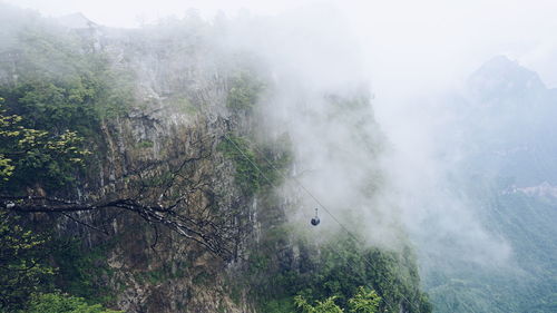 Scenic view of mountains against sky during foggy weather