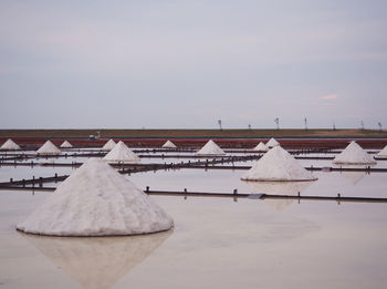 Built structure on snow covered landscape against sky