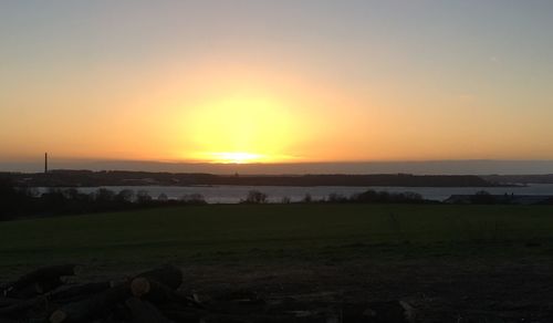 Scenic view of field against sky during sunset