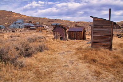 Abandoned building on field against sky