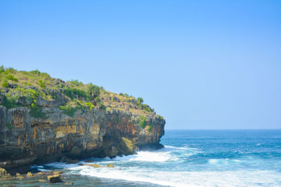 Scenic view of sea against clear blue sky