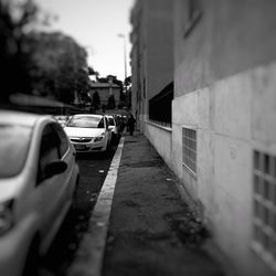 Close-up of car on road against buildings