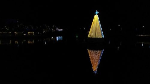 Illuminated building against sky at night