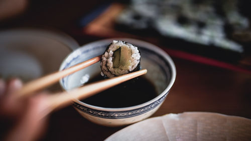 Close-up of sushi on chopsticks
