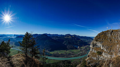 Scenic view of mountains against blue sky