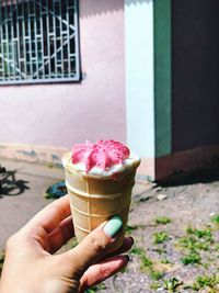 Close-up of hand holding ice cream