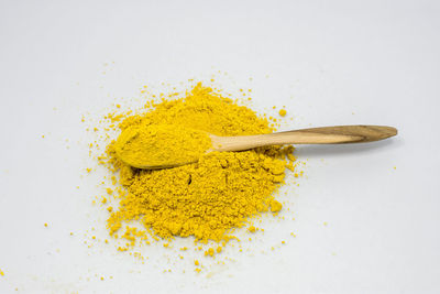 High angle view of yellow leaf on white background