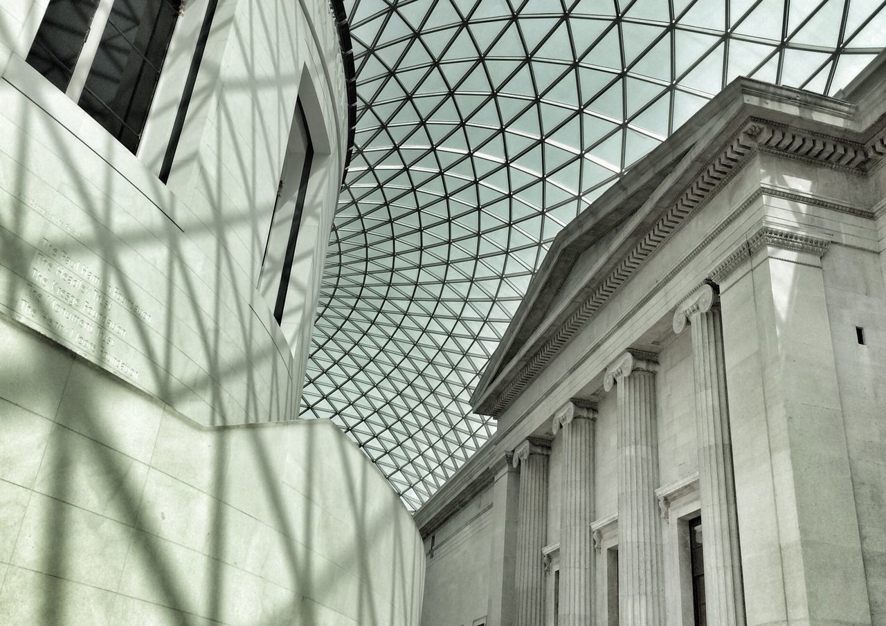 indoors, architecture, built structure, pattern, low angle view, modern, ceiling, design, building, architectural feature, repetition, building exterior, no people, day, directly below, sunlight, glass - material, high angle view, in a row, shadow