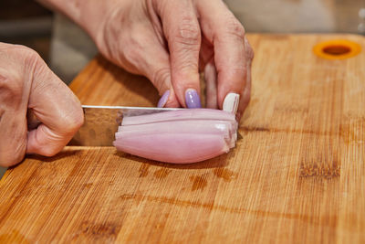 Cropped hands of person preparing food on table