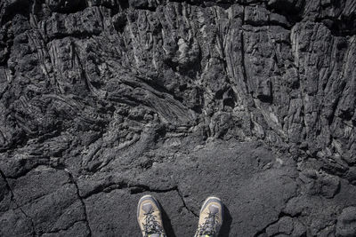 Low section of person standing on rock