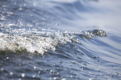 Close-up of water splashing on beach