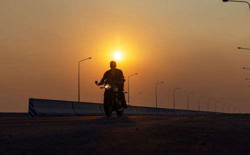 Young man riding big bike motocycle on asphalt high way against, motorbike man has freedom