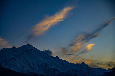 Scenic view of snowcapped mountains against sky during sunset