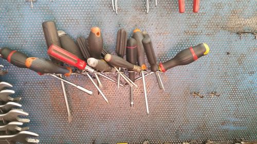 Close-up of screwdrivers on metal at workshop