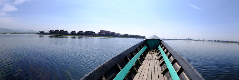 Cropped image of boat at lake against sky