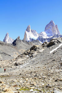 Scenic view of snowcapped mountains against clear blue sky