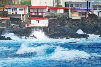 Scenic view of sea against buildings