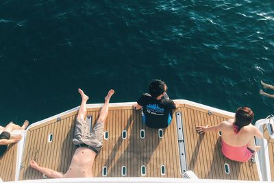 High angle view of people sitting on jetty