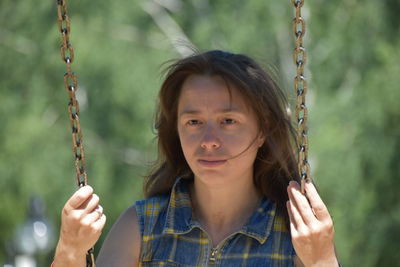 Portrait of a smiling girl on swing