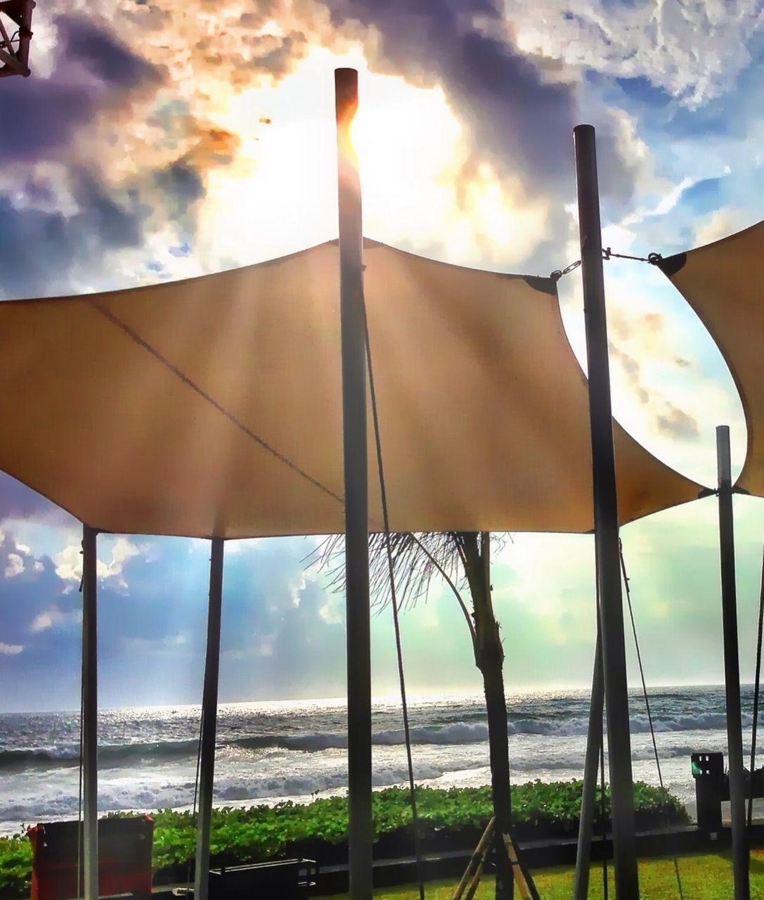 sky, cloud - sky, sea, horizon over water, built structure, cloudy, cloud, water, architecture, nature, sunlight, tranquility, beach, railing, scenics, architectural column, tranquil scene, beauty in nature, fence, low angle view