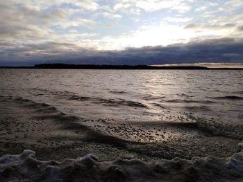 Scenic view of beach against sky during sunset