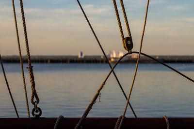 Sailboat moored in lake during sunset