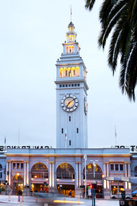 Low angle view of clock tower against building